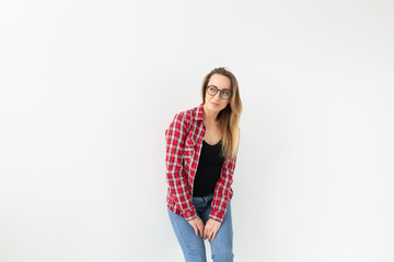 people, style and beauty concept - beautiful standing woman model posing with hands in pockets on a white background.