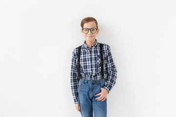 teenager, children and fashion concept - kid dressed in plaid shirt posing over white background