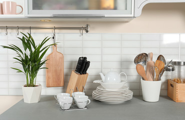 Clean dishes and utensils on kitchen counter