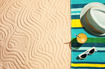 Flat lay composition with beach objects and space for text on sand