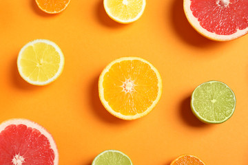 Different citrus fruits on color background, flat lay