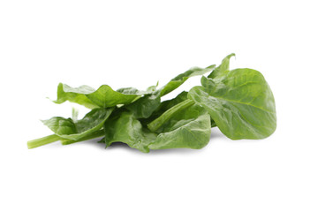 Fresh leaves of spinach isolated on white