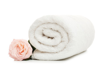 Fototapeta na wymiar Clean rolled towel with flower on white background