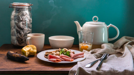 VIntage on table for breakfast in English style with han, mushroon, apple and tea.