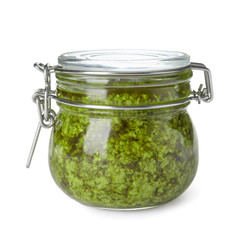 Jar of tasty pesto sauce isolated on white