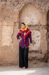 young beautiful iranian lady on a streets of an old village in Iran