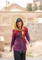 young beautiful iranian lady outside in an old village