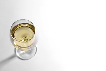 Glass of delicious wine on white background, above view