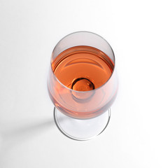 Glass of delicious wine on white background, above view