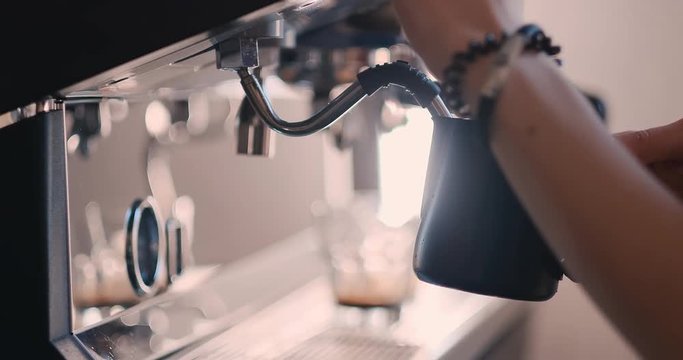 Barista drops off preasure steam from coffee machine.