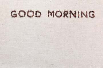 Good morning letter sign from coffee beans isolated on top of linea canvas.