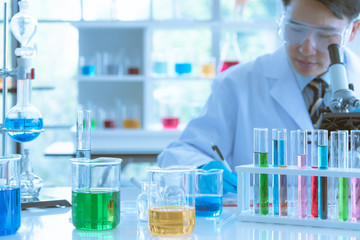 Scientist adjusting microscope for experiment.