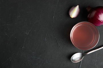Flat lay composition with onion syrup in bowl and space for text on table