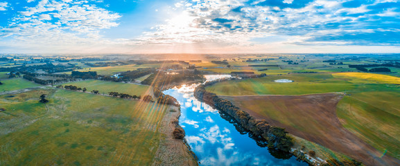 Beautiful sunset over Hopkins River and countryside in Australia - aerial panorama © Greg Brave