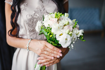 bride with a bouquet and a ring