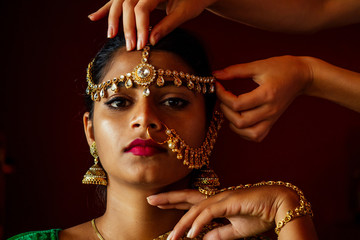 indian beautiful female in golden rich jewelery and tradition saree face closeup professional...