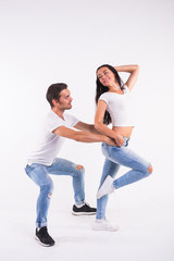 Young couple dancing social latin dance bachata, merengue, salsa. Two elegance pose on white...