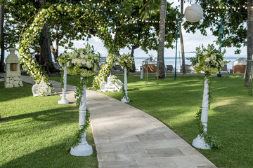 Wedding arch decorated with flowers outdoors. Beautiful wedding set up. Wedding ceremony on green...