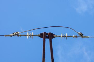 Obraz premium Detail of old electric line with electrical insulators