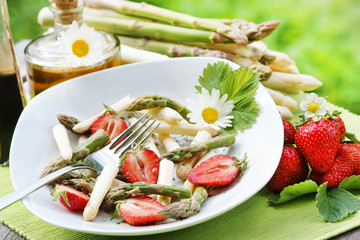 Colorful asparagus salad with strawberries, copy space