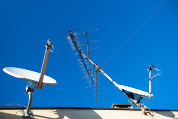Antennas of satellite and analog television on the roof.