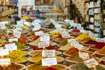 Fototapeta premium Spices in the market, rows of bowls with various colorful spices