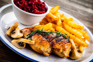 Grilled chicken breast, French fries and vegetables
