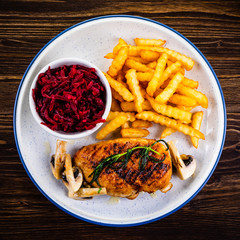 Grilled chicken breast, French fries and vegetables