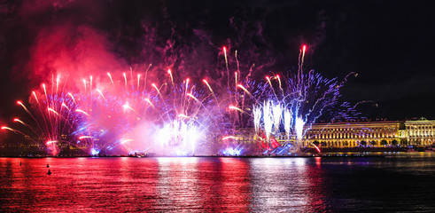 Fireworks over the river. Bright laser show. Holiday in the city. - obrazy, fototapety, plakaty