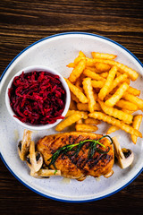 Grilled chicken breast, French fries and vegetables