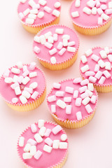 Obraz na płótnie Canvas Colorful cupcakes on a pink background.