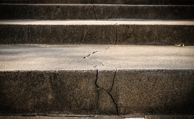Broken old concrete staircase with cracked background texture