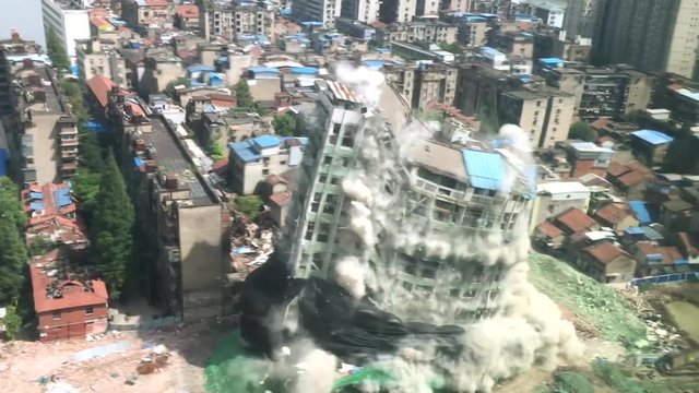 Downtown building demolition by controlled implosion in China