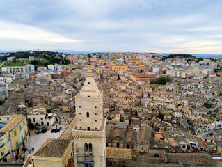 Aerial Panoramic View of the Belltower of the Cathedral of St. Maria La Bruna on Cloudy Sky at Sunset