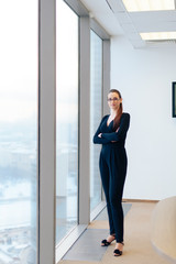 beautiful girl business lady in her office in a skyscraper
