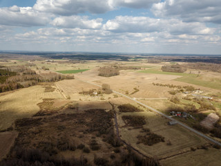 aerial view of countryside fields and forests with small lakes