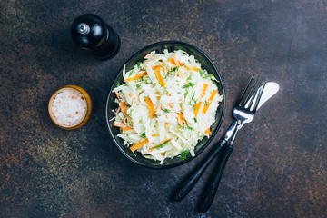 Traditional cole slaw salad in a black bowl
