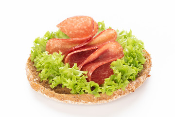 Sandwich with salami sausage on white background.
