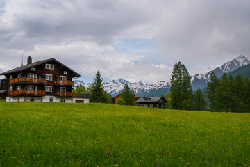 Colorful summer view of small village Ernen canton of Valais, Switzerland in summer day. Outdoor scene in Swiss Alps. Beautiful countryside. Nature landscape. Post card.