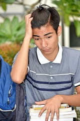 Young Filipino Student Under Stress With Notebooks