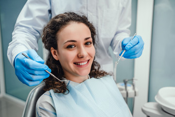 Healthcare and medicine concept.Dentist examines the oral cavity of a young patient on the...