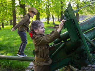 children in military uniform - soldiers and the defenders of the Homeland at the military memorial  of the Victory Day on May 9 in Russia