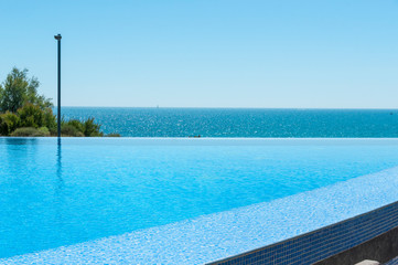 Empty Swimming pool overlooking sea view