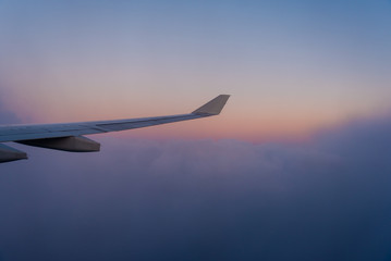 Window seat flying high above the clouds