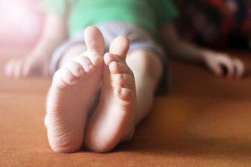The baby's small feet are very close, funny fingers