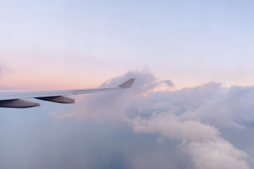 Window seat flying high above the clouds