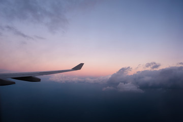 Fototapeta na wymiar Window seat flying high above the clouds
