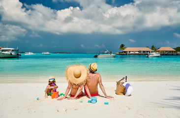 Family with three year old boy on beach