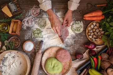 Process of making cooking homemade pasta. Chef make fresh italian traditional pasta. Flat lay. Top view. Frame. Rustic style, toned image.