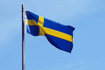 national flag of sweden against blue sky
